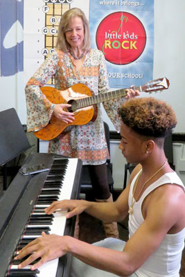 Susan Darrow on guitar with student on piano