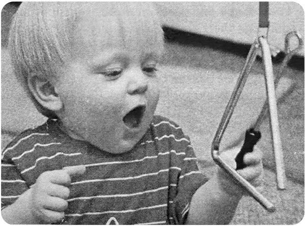 Jake playing a triangle in class (1999)