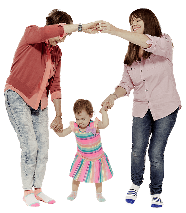 Mom and Grandma holding hands and dancing with toddler