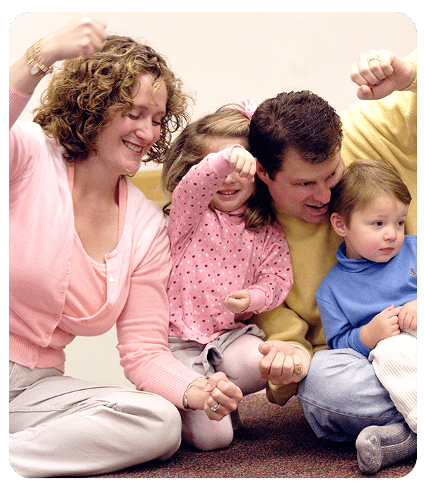 Family pretending to drive an imaginary car and singing
