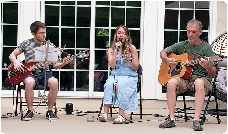 Sitting left to right: Jake with bass, Riley as singer, and Rob with guitar