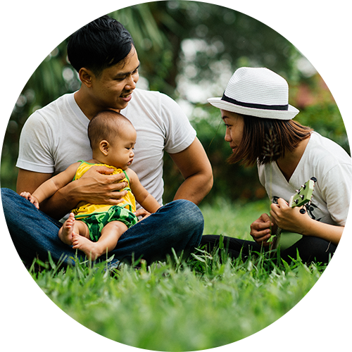 Family with baby making music outside