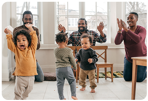 Toddlers Dancing with Parents Clapping Photo Image