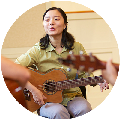 Parent singing and playing guitar