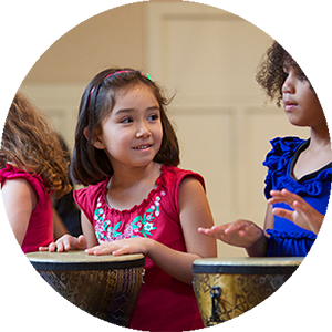 Two children playing drums in a Rhythm Kids class